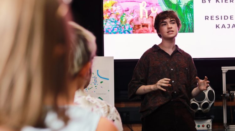 A woman is speaking to an audience