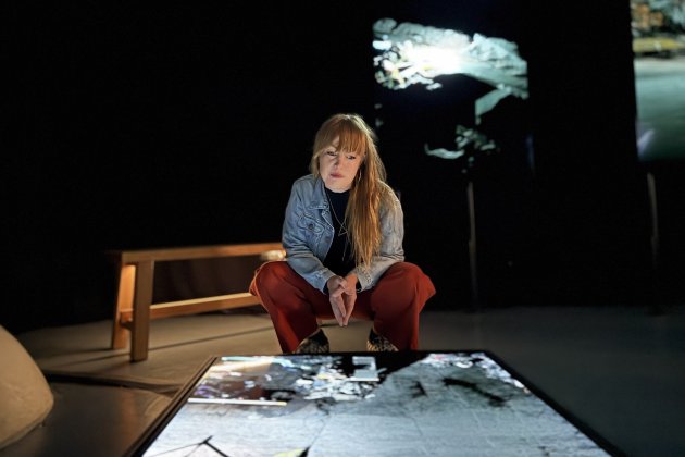 Amy Rose, Undershed Curator is peering down at a screen showing FRAMERATE: Pulse of the Earth