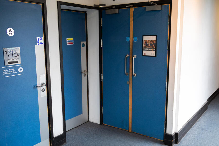 Photo of the entrance doors to Watershed Cinema 1 and the Inclusive toilet entrance next to it.