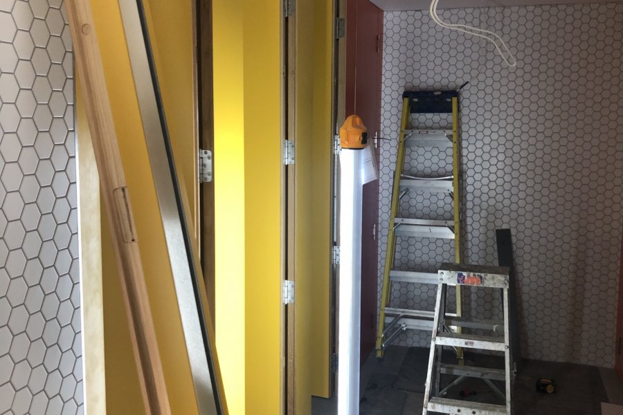 Building work on toilets. Doors and tiles and light fixings