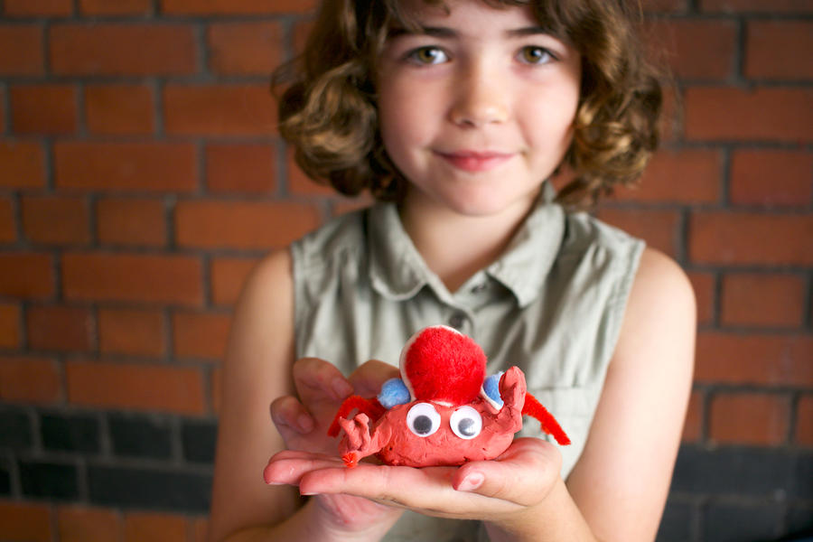 Photo of a child with a clay model made at a Watershed family workshop