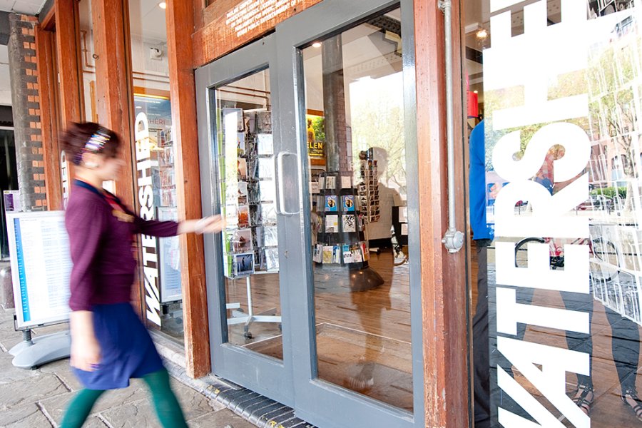 Photo of woman opening the front doors of Watershed