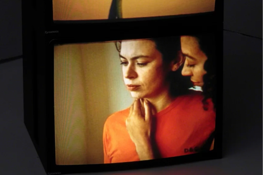 A still of a woman's face. Her eyes downcast.