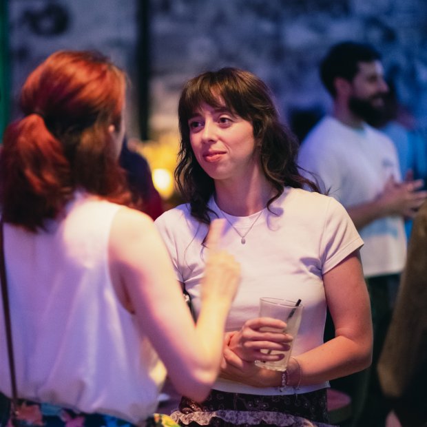 Two women in conversation at a networking event