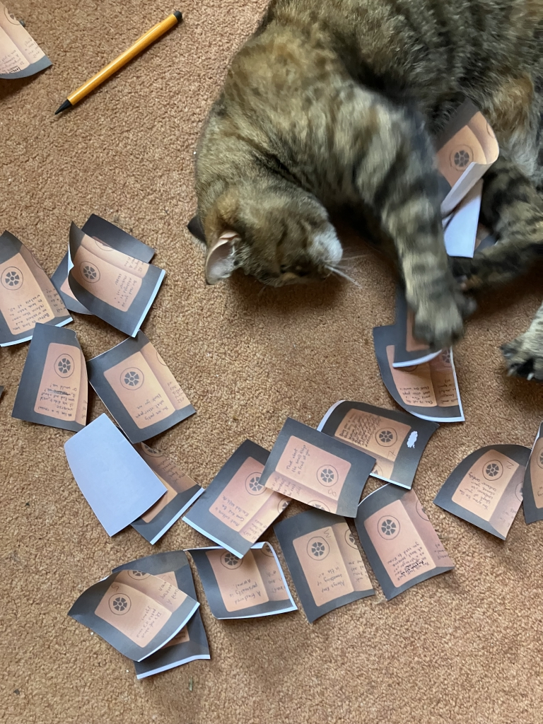 Image of a cat playing with paper
