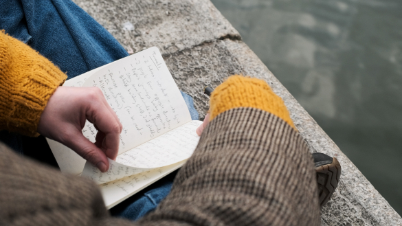 A close up of Geraint’s  notebook, with a body of water as the background.