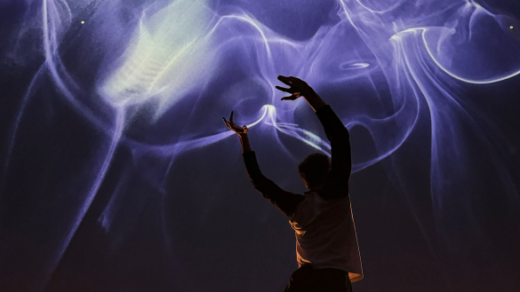 A person dances with their arms in the arm and a beautiful sky at night type background.