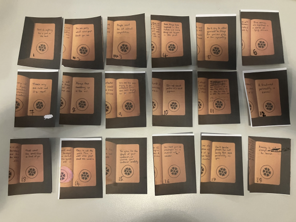 18 small pieces of paper arranged in rows, each with a drawing of a plughole on it and a sentence