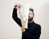 Charlie Williams (Larkhall) holds a handwritten score in front of his face.