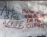 Graffiti that reads: Art is not a crime. Change the Culture not the Climate.