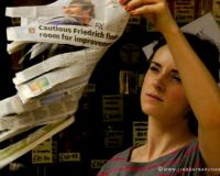 Dancer holding newspaper aloft