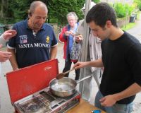 Artist David Lisser cooking insects in his Future food café at Allenheads Village show, 2011