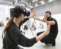 Photo of two people using VR.