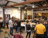 Photo of people socialising in Pervasive Media Studio as part of the February First Friday event.