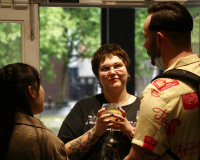 Photo of three people engaged in conversation