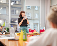 Photo of Rachael Clerke holding a megaphone in an office