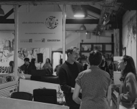 Black and white photo of people gathered in Pervasive Media Studio for an event