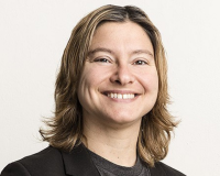 An image of Dr. Melanie Rieback - she is a blonde haired white woman, smiling broadly, in an official headshot, her head backgrounded completely in white.  