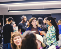 Image of group of people standing and chatting.