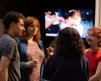 A group of people standing around and talking