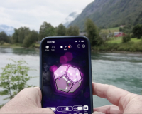 A phone held up in front of some scenery