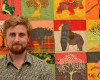 Josh with a prototype of the Communication Quilt