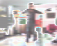 A heavily pixelated image of a person moving in a room