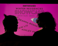 Image of two people in front of a projection
