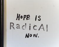 white wall with the text 'Hope is Radical now' 
