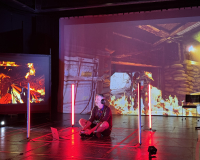 A person sits cross-legged on the floor, wearing headphones, surrounded by vertical red lights. Intense video game scenes with fire project in the background.