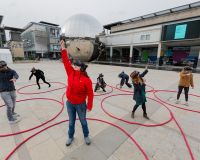 People playing dancing shadows in Millennium Square