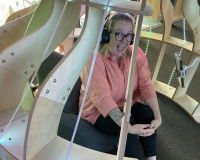 Annie sitting in the joey pod: a timber structure with LED lights.