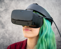 A white woman with green hair, wearing a VR headset