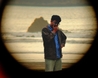 person looking pensively at the sea shore