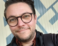 Photo of Matt Gras in front of the Watershed logo