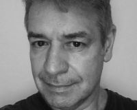 White man in 50s wearing black jumper