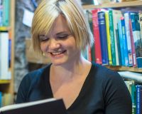 Eleanor Pender, reading a book in Armchair Books, Edinburgh