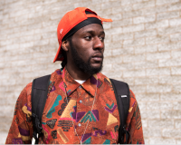 Prince Taylor, wearing an orange baseball cap