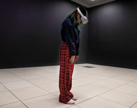 image of a visitor, wearing a VR headset staring at the ground