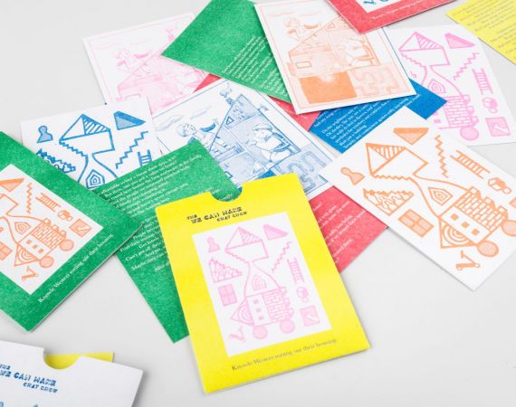 Colourful 'We Can Make Chat Show' riso prints spread out on the table in colours of green and orange, yellow and pink, orange and white, blue and white, and red.