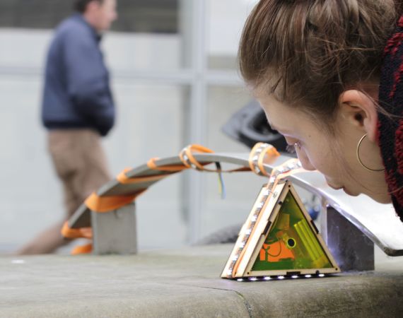 Image of One Five West's work: a woman playing with an interactive artwork.