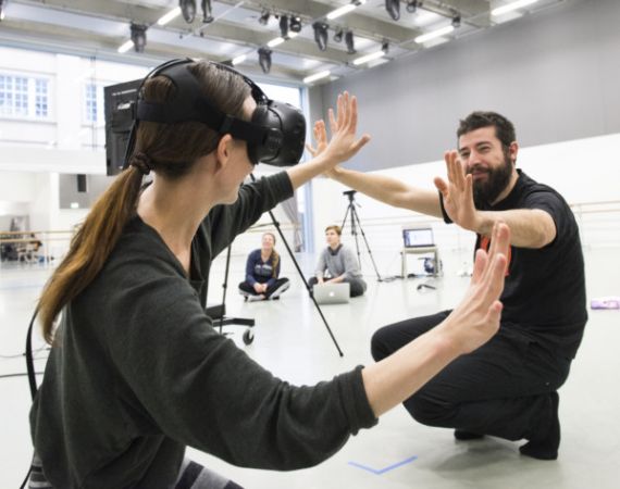 Photo of two people using VR.