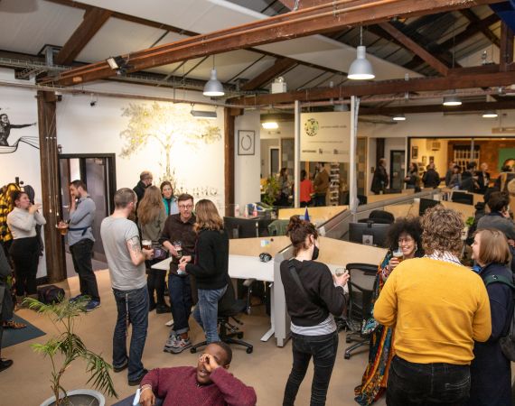 Photo of people socialising in Pervasive Media Studio as part of the February First Friday event.