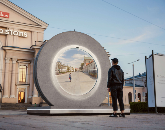 Photo of a portal installation in an outdoor public square with a single figure stood in front