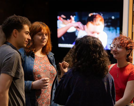 A group of people standing around and talking