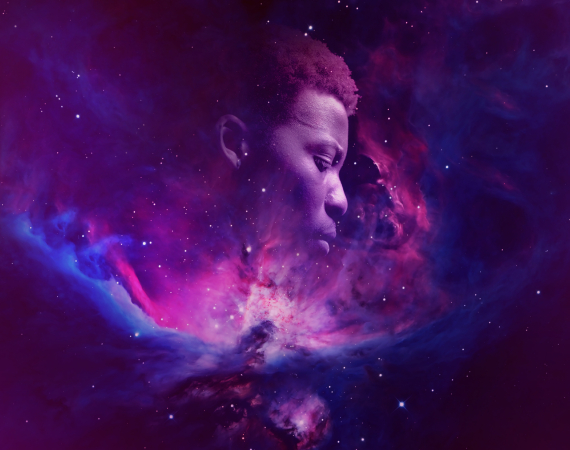 An image of a purple and bluish nebula, in which a human profile can be seen silhouetted in the centre of the image.