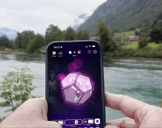 A phone held up in front of some scenery