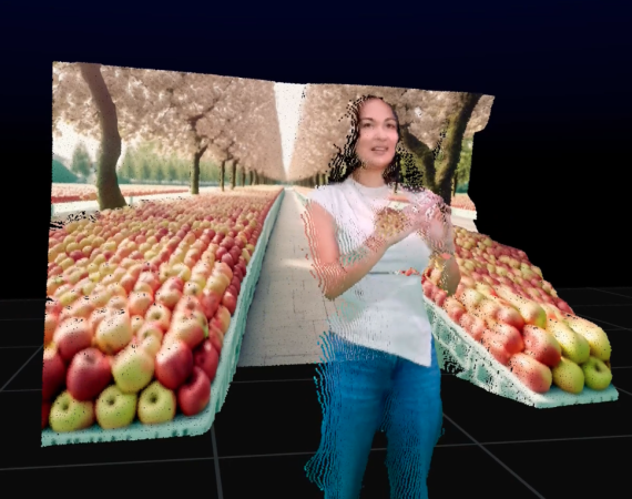 An image of a woman wearing a white t shirt and blue jeans, rendered in a 3D environment, surrounded by two separate shelves of apples, with an apple orchard in the background. She is smiling, looking off camera to the right. 