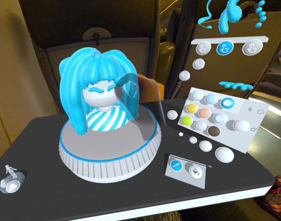 A screenshot from Taru Muhonen's app, Spira - the image depicts a digital render of the app in use; in the centre of the shot, a transparent hand, controlled by the user, fixes a bust with a white face and blue hair. To the right of the bust is a white controller with multi coloured buttons. The bust and controller sits on a black tabletop. 
