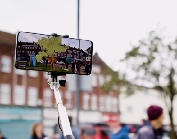 An image of a phone recording its surroundings, with the screen altering the image for the viewer. 